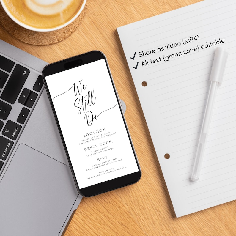 May include: A smartphone displays a wedding invitation with the text "We Still Do." A white pen and lined paper are next to the phone. A cup of coffee and a laptop keyboard are also visible on a wooden surface.