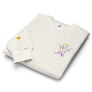 Unisex premium crew neck sweatshirt. Spyro the dragon embroidery on the left chest, gem on the right wrist.