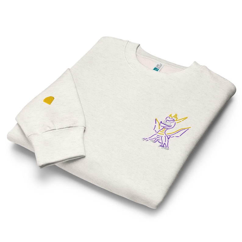 Unisex premium crew neck sweatshirt. Spyro the dragon embroidery on the left chest, gem on the right wrist.