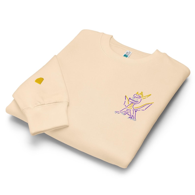 Unisex premium crew neck sweatshirt. Spyro the dragon embroidery on the left chest, gem on the right wrist.