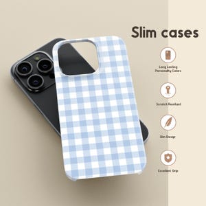 May include: A light blue and white gingham pattern phone case. The phone case is on top of a black phone. The text "Slim cases" is in the upper right corner. Additional text includes "Long Lasting Personality Colors", "Scratch Resistant", "Slim Design", and "Excellent Grip".