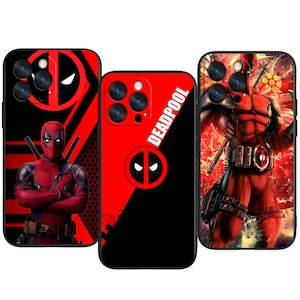 May include: Three phone cases with Deadpool designs. The cases are mainly red and black, with images of Deadpool in different poses. One case has the Deadpool logo, and another has the word "Deadpool" in white.