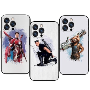 May include: Three phone cases with superhero designs. One features Iron Man in a red and gold suit with a blue and purple background. Another depicts Hawkeye kneeling with a bow and arrow. The third shows Rocket Raccoon with a large weapon.