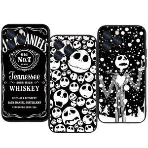 May include: Three black phone cases. One features the Jack Daniel's Whiskey label, the second has a pattern of Jack Skellington faces, and the third depicts Jack Skellington in a snowy scene. All cases have camera cutouts.