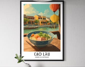 May include: Framed art print featuring a bowl of Cao Lầu noodles, chopsticks, and a scenic view of a Vietnamese town. The print includes the text "CAO LÂU MADE IN VIETNAM". The scene is set with colorful lanterns and a river.