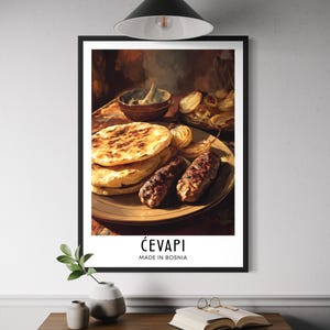 May include: A framed print featuring a culinary still life of ćevapi, a Balkan dish. The image shows grilled minced meat, flatbread, and onions on a plate. The text "Ćevapi Made in Bosnia" is displayed at the bottom.