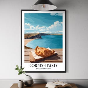 May include: A framed print depicting a coastal scene with a blue sea, sandy beach, and a sky filled with clouds. A golden Cornish pasty rests on a wooden board. The text "CORNISH PASTY MADE IN ENGLAND" is displayed below the image.