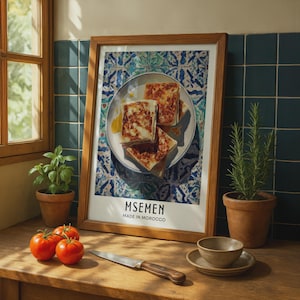 May include: A framed wall art print featuring a plate of square-shaped Msemen flatbreads on a blue and white patterned tile background. The text at the bottom of the print reads MSEMEN MADE IN MOROCCO in black capital letters on a white border.