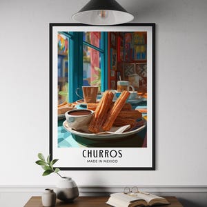 May include: A framed print featuring a vibrant illustration of churros and chocolate. The image shows a plate of churros with a cup of chocolate, and the text "CHURROS MADE IN MEXICO". The scene is set in a colorful cafe with a window view.