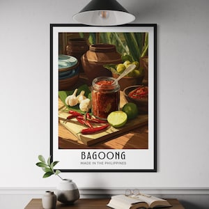 Op de afbeelding: Een ingelijste print met een stilleven van Filipijns eten. De afbeelding toont een pot Bagoong, rode pepers, knoflook en limoenen op een houten plank. De tekst "Bagoong Made in the Philippines" staat onderaan.