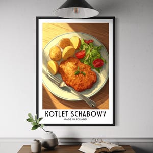 May include: A framed print of a Polish Kotlet Schabowy meal. The plate features a breaded pork cutlet, roasted potatoes, salad, and tomatoes. The text "KOTLET SCHABOWY MADE IN POLAND" is displayed at the bottom of the print.