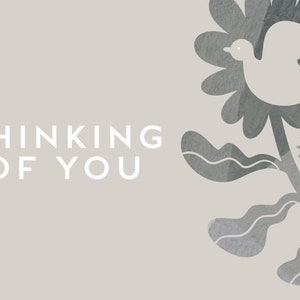 May include: A gray and white card with the text "Thinking of You" on the left side. The right side features a stylized gray floral design with a white dove flying above it.