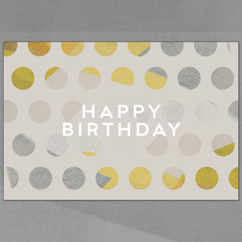 Puede incluir: Una tarjeta beige con un patr&oacute;n de lunares en tonos grises y amarillos. El texto "HAPPY BIRTHDAY" est&aacute; impreso en blanco en el centro de la tarjeta.
