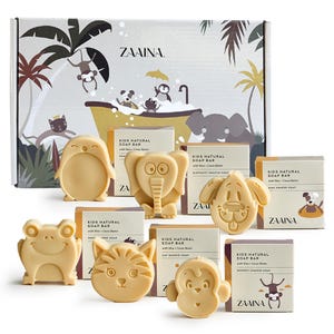 May include: A collection of six light beige animal-shaped soap bars, including a penguin, elephant, dog, frog, cat, and monkey, each paired with its own branded box labeled Kids Natural Soap Bar with Shea and Cocoa Butter, in front of a gift box.