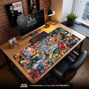 May include: A large desk mat featuring a colorful collage of cartoon characters. The mat, measuring 23.6" x 47.2", is placed on a wooden desk with a computer, keyboard, and other accessories. The text "ARTHUR DESKMAT" is visible.