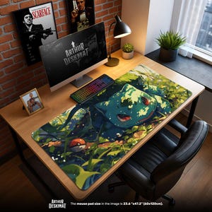 May include: A large desk mat featuring a Bulbasaur design with a vibrant green and blue color scheme. The mat includes a Pokeball and leafy foliage. The size is 23.6" x 47.2". The text "ARTHUR DESKMAT" is visible.