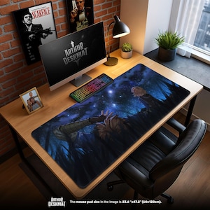 May include: A large rectangular desk mat with a fantasy art design. The mat features a dark blue and black forest scene with a figure reaching upwards. The text "ARTHUR DESKMAT" is at the bottom. The mouse pad size is 23.6" x 47.2".