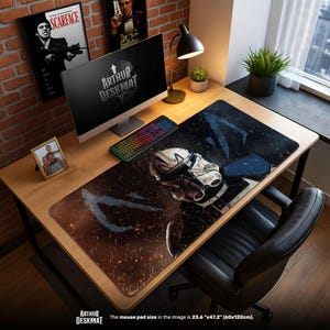 May include: A large desk mat featuring a Star Wars character design. The mat is black with a detailed image of a helmet and other design elements. The mat measures 23.6" x 47.2" (60x120cm). The text "ARTHUR DESKMAT" is visible.