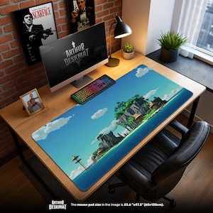 May include: A large rectangular desk mat with a tropical island scene, featuring a blue sky, white clouds, and turquoise water. The mat is 60cm x 120cm. The words "ARTHUR DESKMAT" are printed on the mat. A computer, keyboard, and other desk accessories are on the desk.