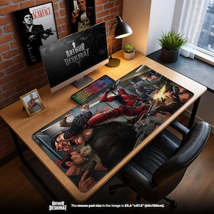 May include: A large rectangular desk mat featuring a comic book style illustration of Deadpool in action. The mat is 23.6" x 47.2" and has the text "ARTHUR DESKMAT" at the bottom. The scene depicts a violent encounter with guns and explosions.