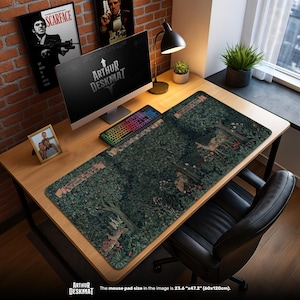 May include: A large desk mat with a forest scene featuring deer, trees, and foliage. The mat is rectangular and covers most of the desk surface. The mouse pad size is 60cm x 120cm. The words "ARTHUR DESKMAT" are printed on the mat.