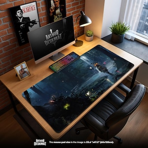 May include: A large desk mat featuring a dark fantasy forest scene, a computer, and a keyboard. The mat measures 60cm x 120cm. The desk also has a lamp, a small plant, and framed artwork. The text "ARTHUR DESKMAT" is visible.