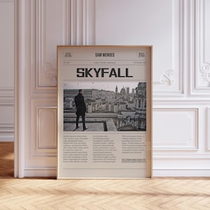 May include: A framed poster featuring the movie "Skyfall." The poster has a newspaper-like design with the title in large, bold letters. A man in a black coat stands on a rooftop. The poster includes text about the movie's plot and cast.