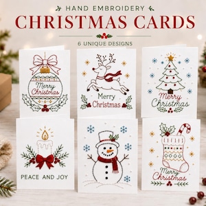 May include: Six white greeting cards featuring hand embroidery designs of a Christmas ornament, a reindeer, a Christmas tree, a candle, a snowman, and a stocking. Each card includes festive text like Merry Christmas or Peace and Joy.