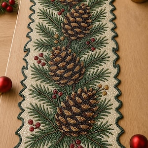 May include: Beaded Christmas table runner featuring a repeating pattern of pine cones, evergreen branches, and red berries. The runner has a scalloped edge and is primarily cream, green, and brown. Festive holiday decor.