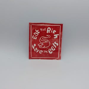 eat the rich save the eels linocut print vinyl sticker from hand carved linoleum block in red black or blue (one of a kind)
