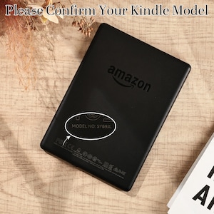 May include: Black Kindle e-reader with the Amazon logo. The text "Please Confirm Your Kindle Model" is at the top. The model number SY69JL is circled on the back of the device.