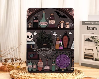 May include: A tablet case featuring a whimsical illustration of a witch's shelf. The design includes potion bottles, a skull, a spiderweb, and a crystal ball. The color palette is dark with accents of green, purple, and brown.