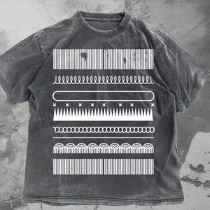 May include: A charcoal gray t-shirt featuring a series of white geometric designs. The designs include vertical lines, wavy lines, and other abstract shapes. The shirt has a vintage, washed appearance.