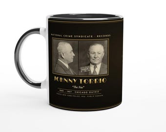 May include: A black ceramic mug featuring a vintage mugshot of Johnny Torrio, labeled The Fox, with the text National Crime Syndicate Records, 1882-1957 Chicago Outfit, and Photo New York Police, 1936 Public Domain printed in gold.