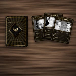 May include: A card game box titled Made Men with a black and gold sunburst design, accompanied by three playing cards featuring black and white portraits of historical figures including Carlo Gambino, Meyer Lansky, and Dutch Schultz with statistics.