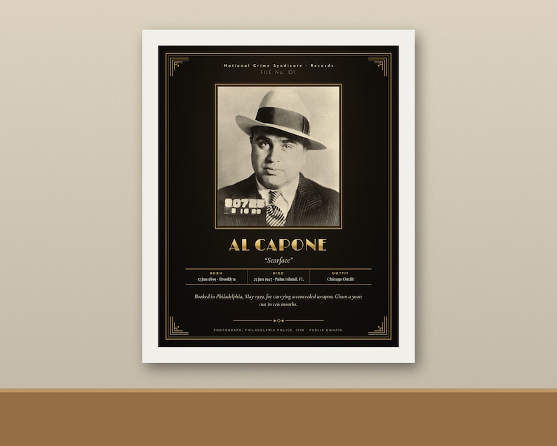 May include: A black and gold framed poster featuring a vintage mugshot of Al Capone wearing a fedora and suit. The text includes his name, nickname Scarface, birth and death dates, and a brief historical summary of his 1929 arrest in Philadelphia.