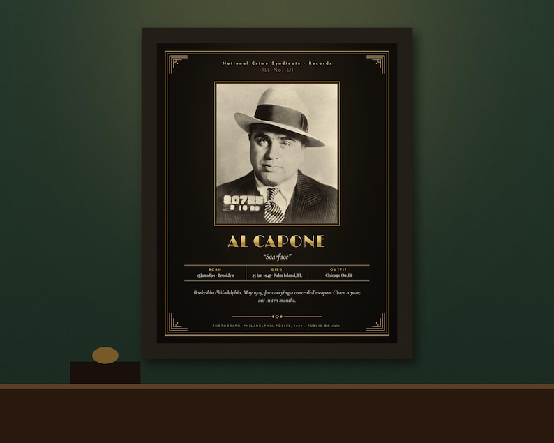 May include: A framed black and gold poster featuring a vintage mugshot of Al Capone wearing a fedora and suit. The text includes his name, nickname Scarface, birth and death dates, and biographical details from the National Crime Syndicate Records.