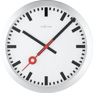 May include: A round wall clock with a white face and a silver-colored frame. The clock features black hour markers and hands, with a red second hand. The brand name "NEXTIME" is printed in the center. The clock's diameter is approximately 12 inches.