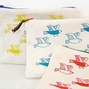 May include: Three zippered pouches with different bird designs. The first pouch has yellow birds, the second has blue birds, and the third has red birds.