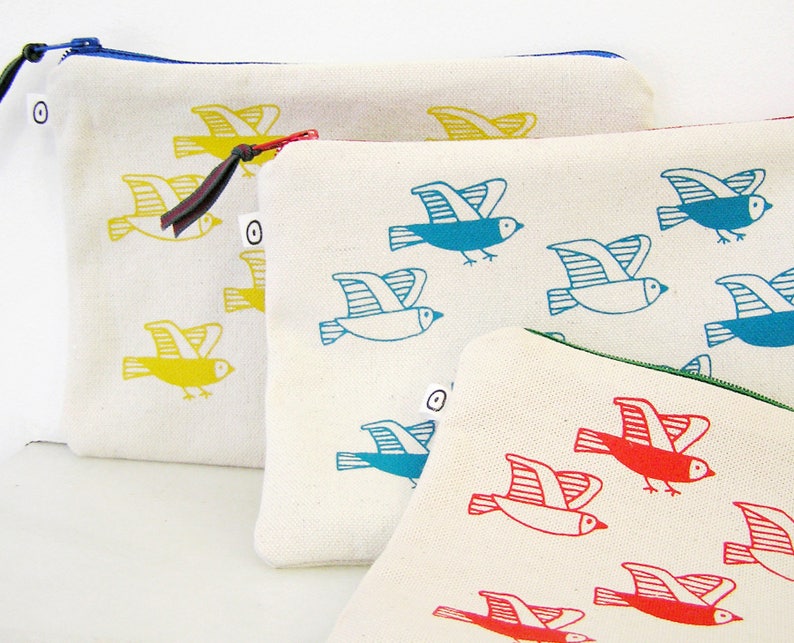 May include: Three zippered pouches with different bird designs. The first pouch has yellow birds, the second has blue birds, and the third has red birds.