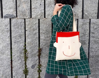 Unique gifts for women: get a fun tote bag with a smiley boy face, hand printed in red by Olula. Canvas tote bag a Tote bag for him or her.