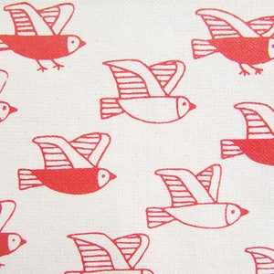 May include: A white background with a pattern of red flying birds. The birds are stylized and have a simple design.