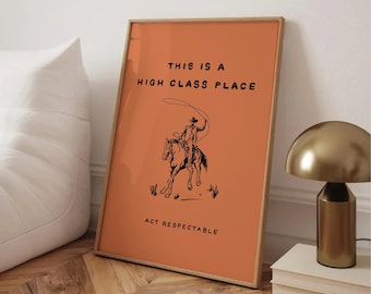 May include: Framed art print with an orange background and a cowboy illustration. The text reads "THIS IS A HIGH CLASS PLACE" and "ACT RESPECTABLE". The artwork is in a wooden frame.
