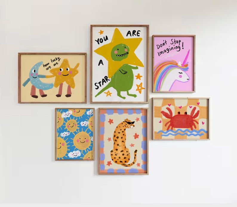 May include: A collection of framed art prints featuring whimsical illustrations. The artwork includes a yellow star with a green creature, a unicorn, a crab, a cheetah, smiling suns, and a moon and star. Text includes "You are a star" and "Don't Stop Imagining!"