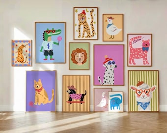 May include: A collection of framed art prints featuring whimsical animal illustrations. The artwork includes a cheetah, crocodile, lion, dalmatian, cat, dachshund, duck, elephant, and a llama, each with unique outfits and accessories. The prints are in various colors.