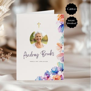 Könnte beinhalten: Eine Trauerprogramm-Vorlage mit einem kreisförmigen Porträt, einem goldenen Kreuz und dem Text Audrey Brooks, March 5, 1947 - April 28, 2025. Das Design zeigt florale Aquarellakzente in Orange, Violett und Blau entlang der rechten Seite.
