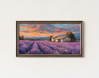 May include: Framed painting of a lavender field at sunset. The artwork shows rows of purple flowers leading to a small stone building. The sky is filled with orange, pink, and blue hues.