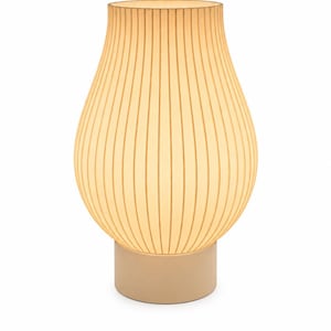 May include: A table lamp with a bulbous, ribbed, translucent cream-colored shade that emits a soft, warm glow. The lamp features a cylindrical, solid cream-colored base that supports the rounded, vertically textured upper section.