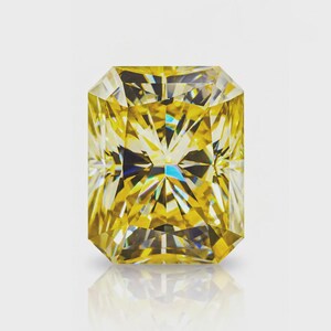 May include: A stunning, rectangular-cut yellow diamond. The facets of the gemstone catch the light, producing a dazzling display of colour and sparkle. The diamond is set against a white backdrop, emphasising its clarity and brilliance. A symbol of luxury and elegance.