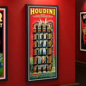 May include: A framed vintage poster featuring the word "HOUDINI" in yellow letters. The poster depicts a man upside down in a water torture cell. The text reads "HIS OWN ORIGINAL INVENTION THE GREATEST SENSATIONAL MYSTERY EVER ATTEMPTED IN THIS OR ANY OTHER AGE."